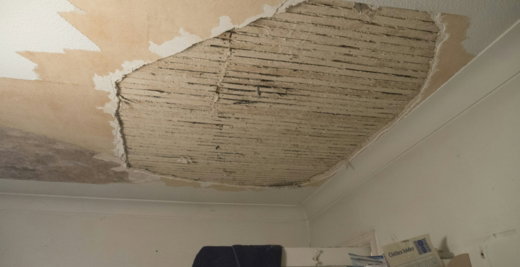 A room with a ceiling that has been torn off