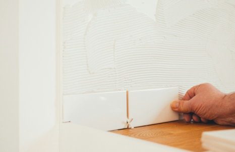 person holding white tile