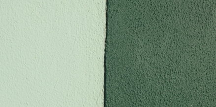 Two textured walls, one light green, one dark green