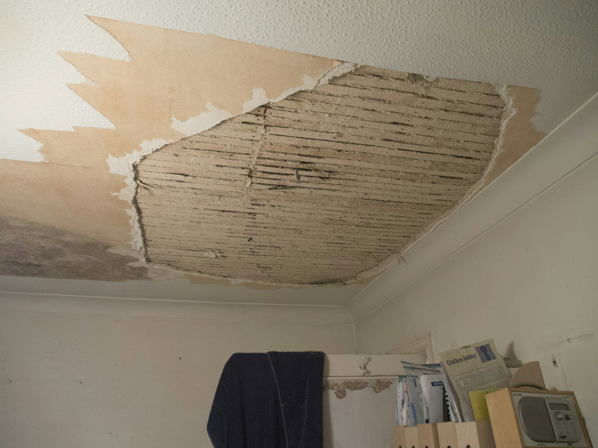 A room with a ceiling that has been torn off